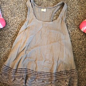 Beige tank top with detailing around the edges